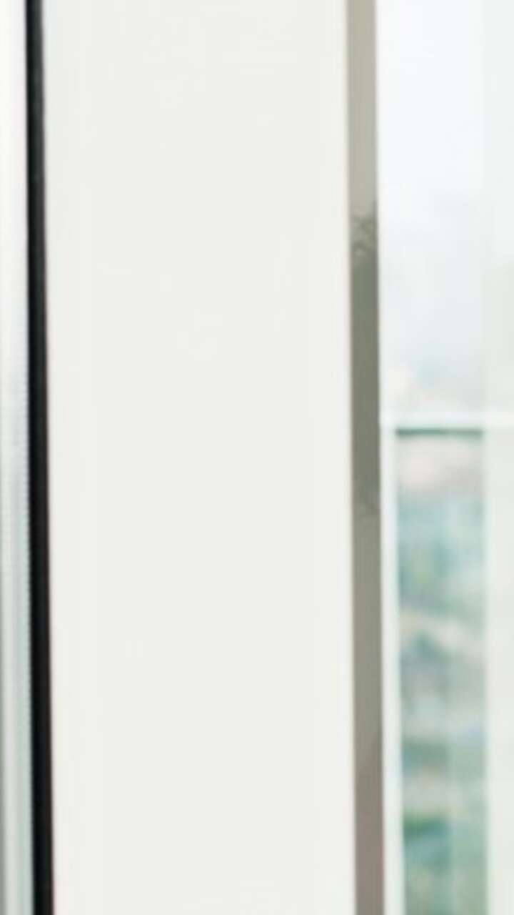 Woman in red dress leaning against a window