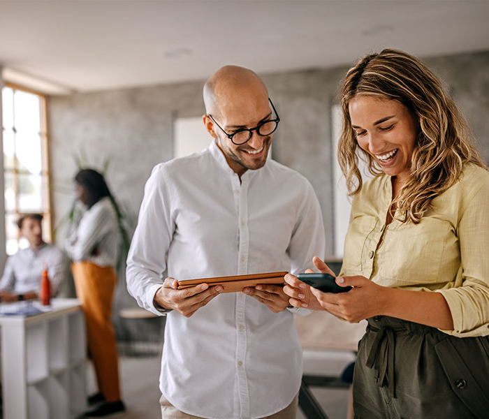 Woman and man looking at tablet