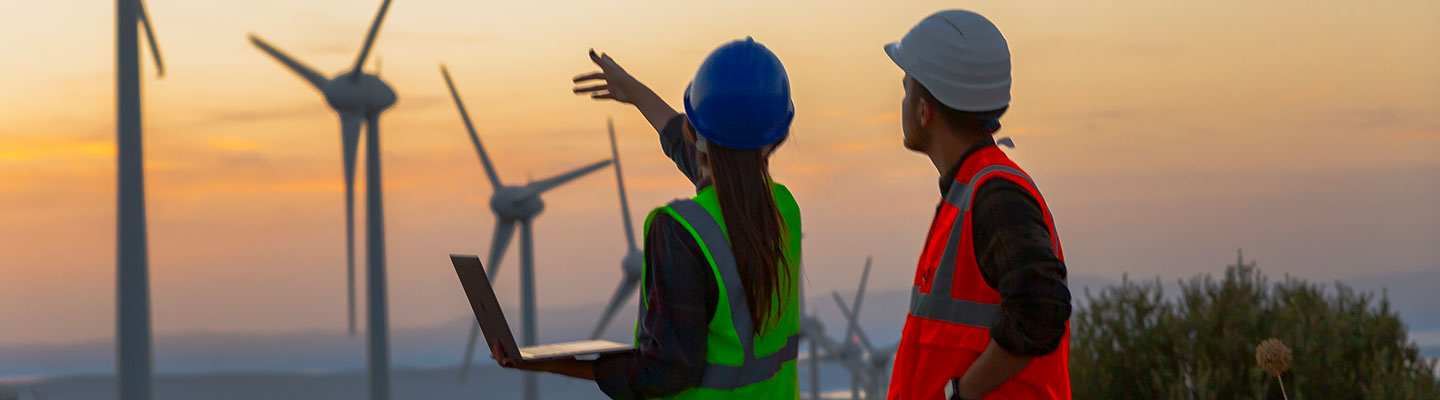 Renewable energy - two people examine wind turbines