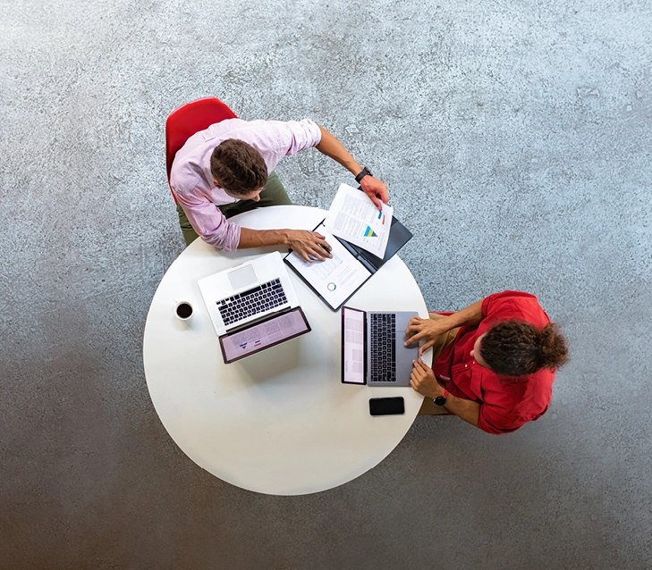 Two people using laptops