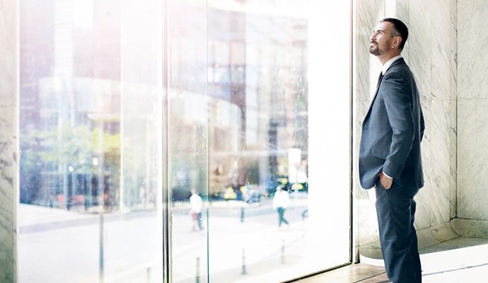 A man standing in front of the window