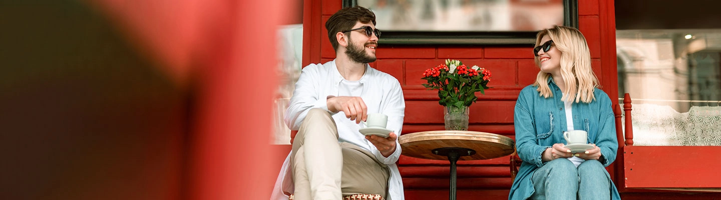 Couple drinking coffee outside